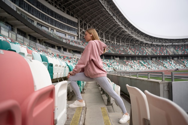 Free photo full shot woman stretching outside