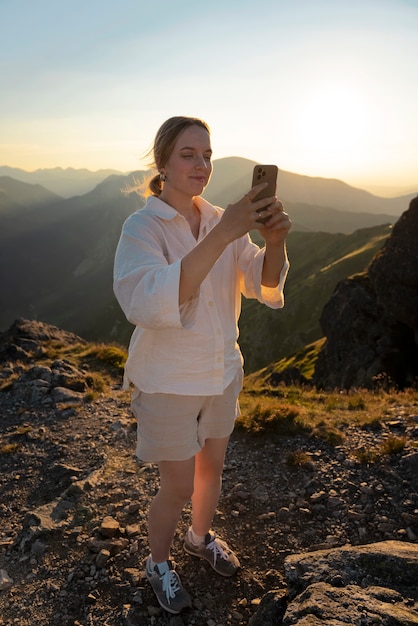 Free Photo full shot woman taking selfie on mountain