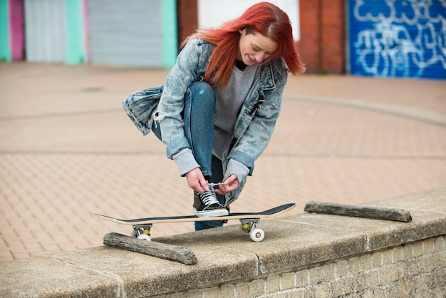 Full shot woman tying her shoelaces