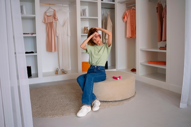 Free photo full shot woman using dry shampoo at home