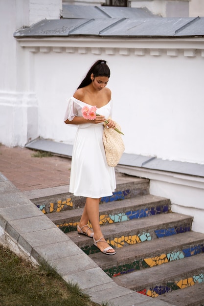 Free photo full shot woman walking down stairs