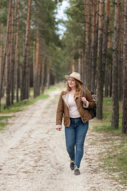 Free photo full shot woman walking in nature