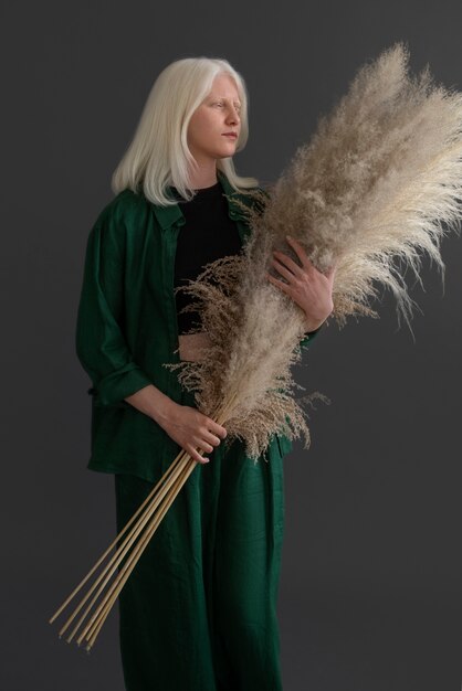 Full shot woman with albinism posing in studio