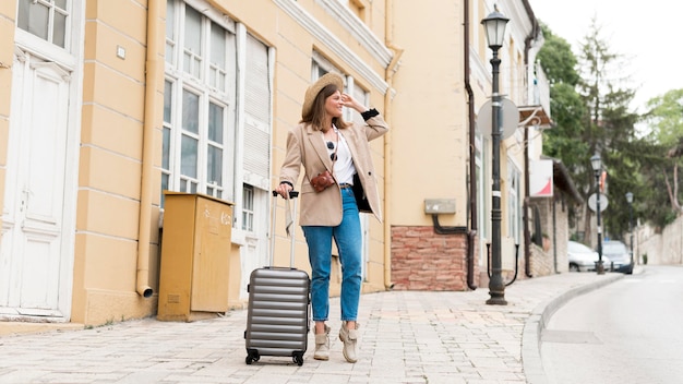 Full shot woman with baggage