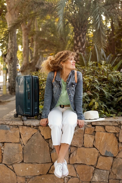 Free Photo full shot woman with baggage