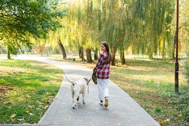 Full shot woman with best friend in the park