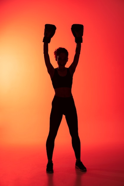 Free photo full shot woman with boxing gloves