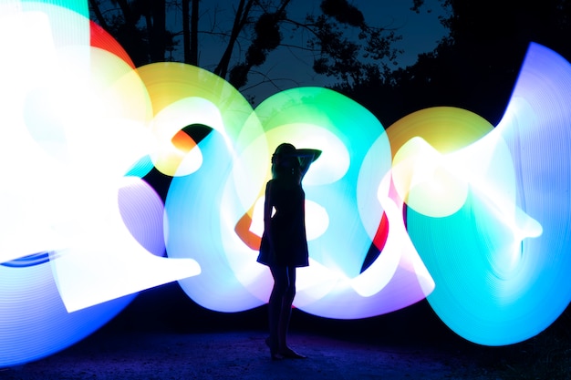 Free Photo full shot woman with colorful lights