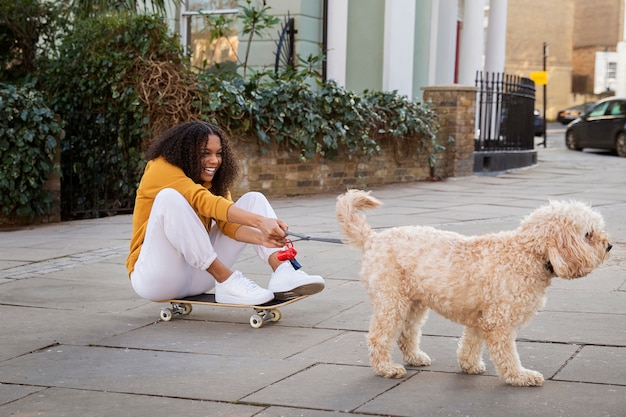 Free Photo full shot woman with cute dog outdoors