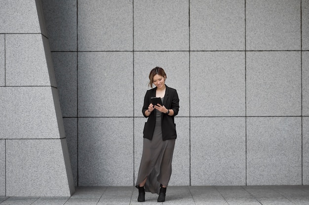 Free photo full shot woman with device