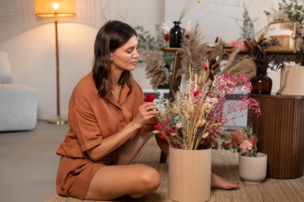 Full shot woman with dried flowers