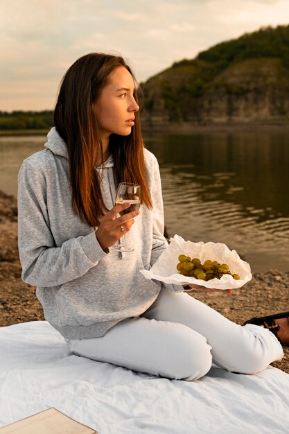 Full shot woman with grapes and wine