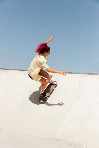 Full shot woman with skateboard outdoors