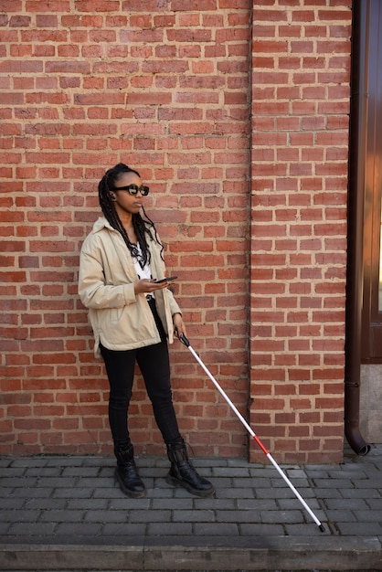 Full shot woman with white cane