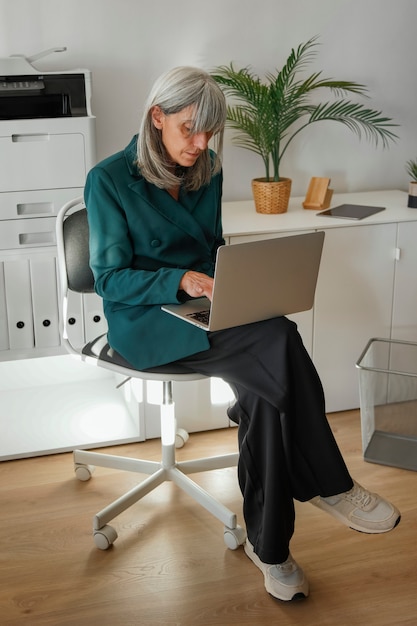 Full shot woman working in office