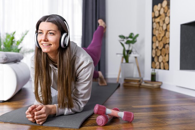 Full shot woman working out at home