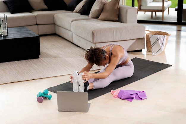 Full shot woman working out on mat