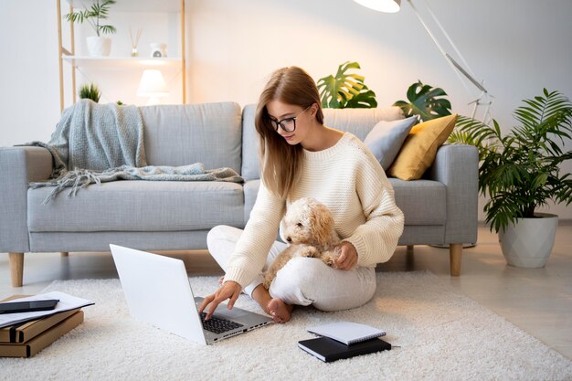 Full shot woman working with cute dog