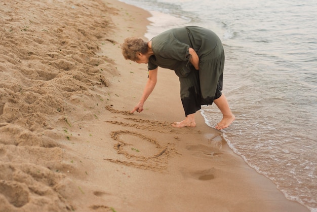 Full shot woman writing on sand