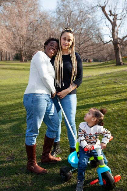 Full shot women and cute girl in park