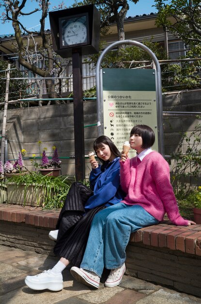 Full shot women enjoying ice cream