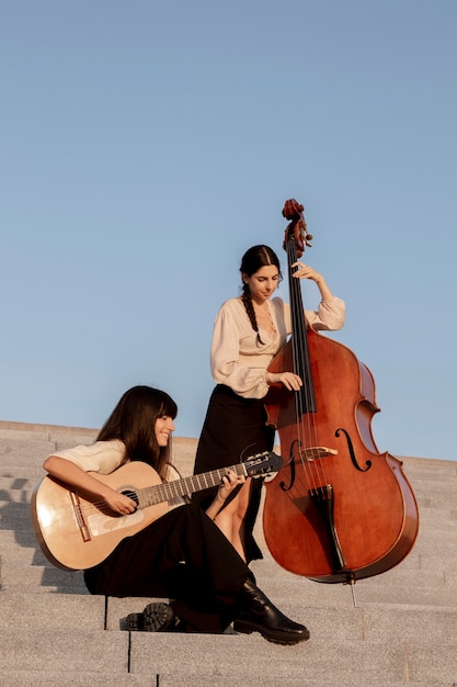 Full shot women making music together