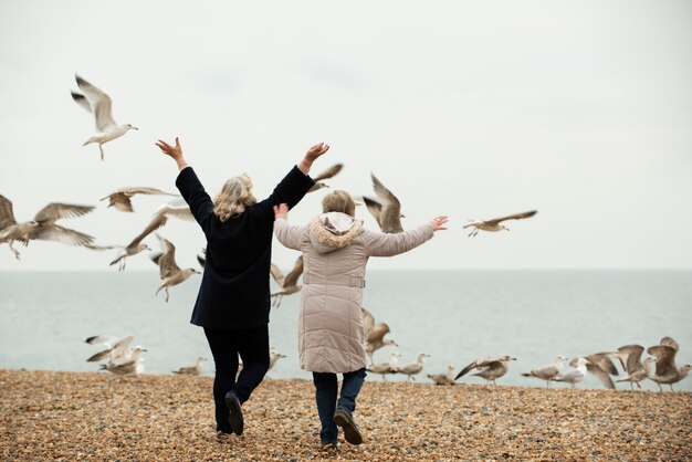 Full shot women outdoors with birds