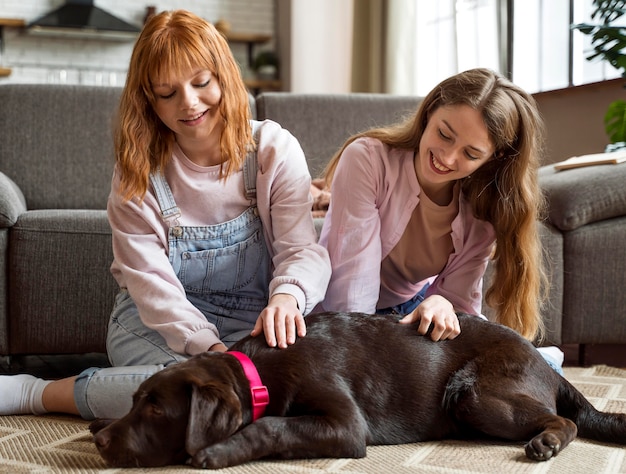 Full shot women petting dog