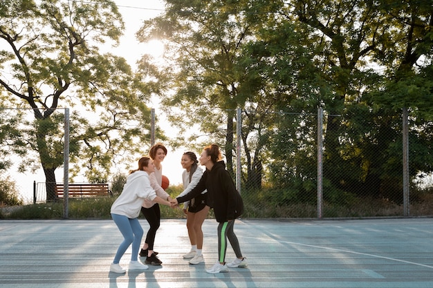 Full shot women playing basketball