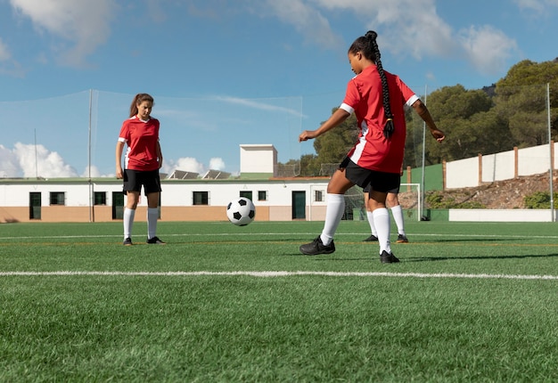 Full shot women playing football