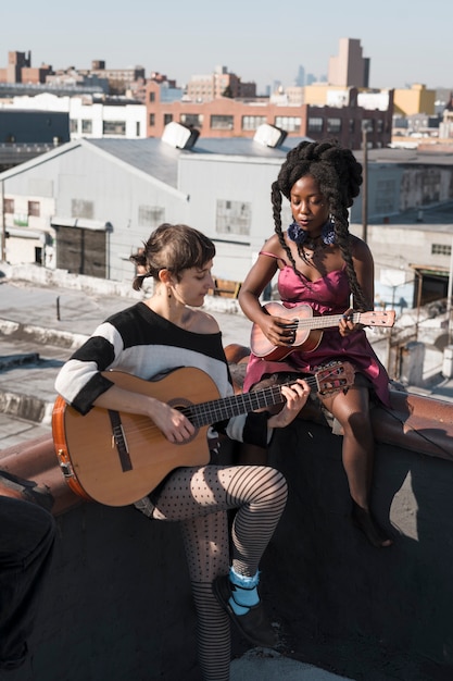 Free Photo full shot women playing at instruments