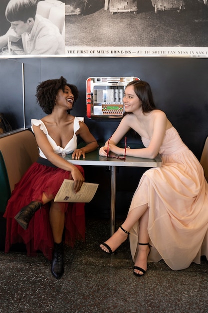 Full shot women sitting at table