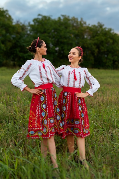 Free Photo full shot women wearing traditional clothes