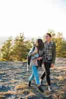 Free photo full shot young couple walking in the park