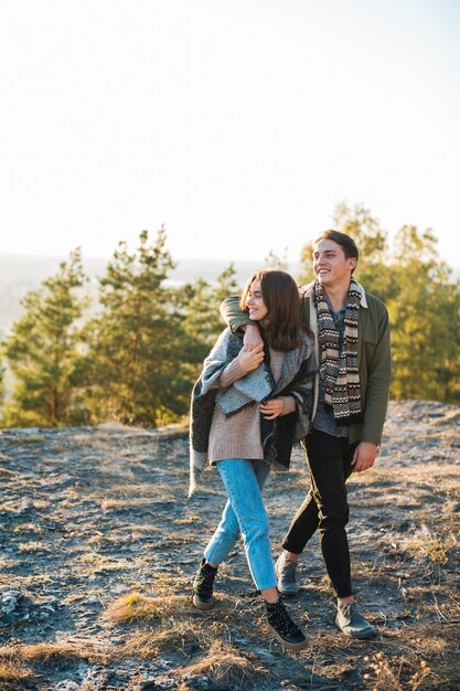 Full shot young couple walking in the park