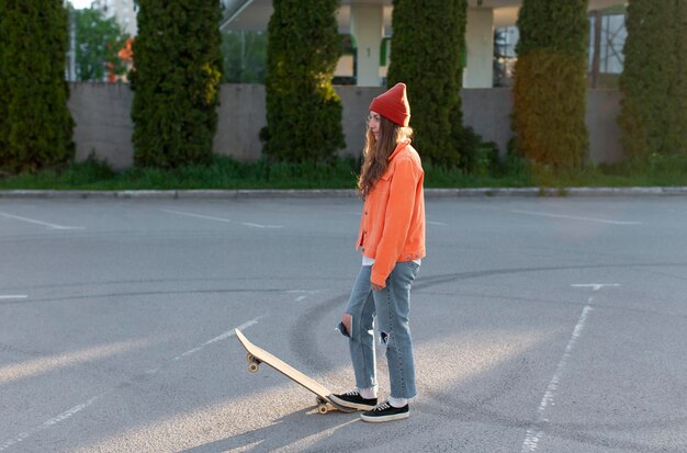 Full shot young girl with skate outdoors