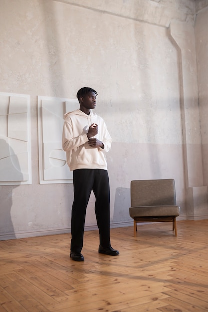 Full shot young man wearing white hoodie