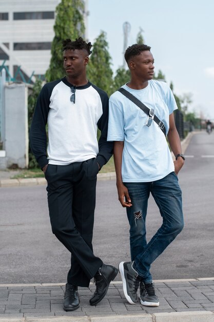 Full shot young men posing together