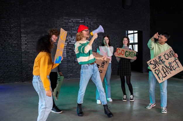 Full shot young people protesting together