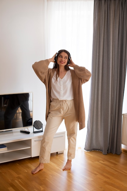 Full shot young woman spending time at home