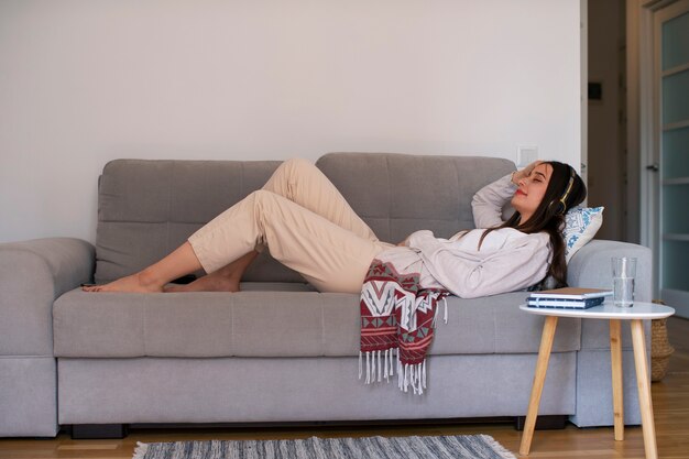 Full shot young woman spending time at home