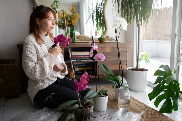 Full shot young woman with orchid