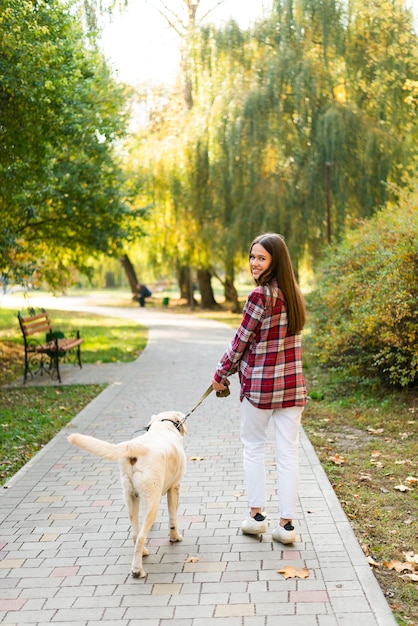 Full show woman out for a walk with her dog