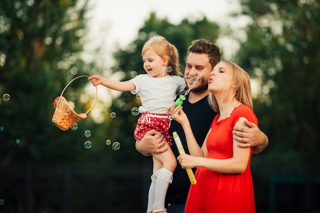 Free photo fun family time while blowing soap bubbles