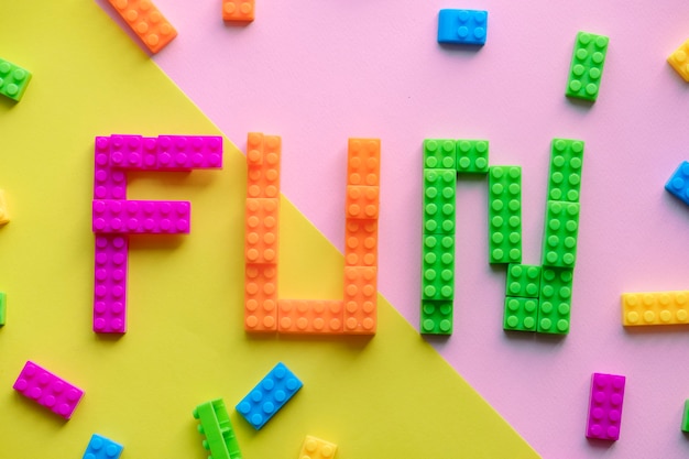 Free photo fun spelled word with plastic blocks background