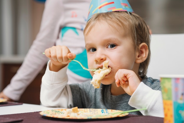 Free Photo funny boy enjoying birthday cake