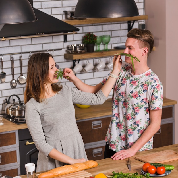 Free Photo funny couple making mustache from greens