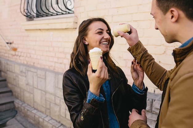 Funny couple playing with ice cream