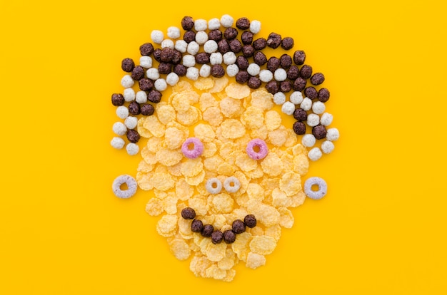 Free photo funny face made with cornflakes and cereals