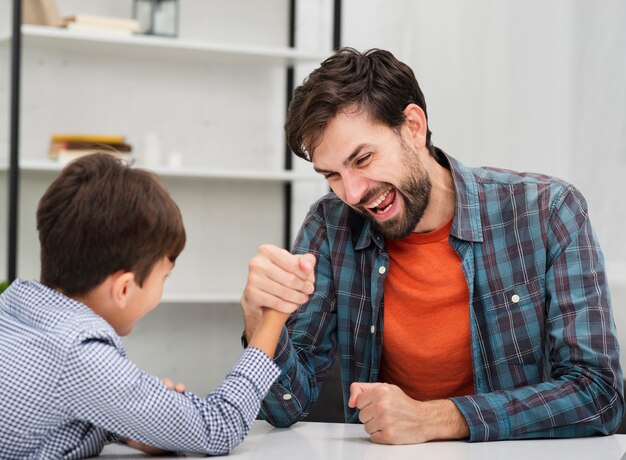 Funny father making skandenberg with his son